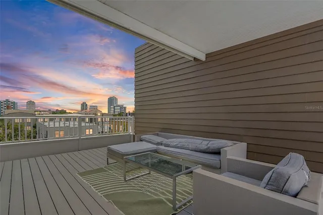 a view of a balcony with furniture