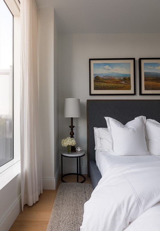 380 Harrison Avenue, Unit 12F Boston, MA 02118 - Photo 21 of 38 a spacious bedroom with a bed and a lamp on table