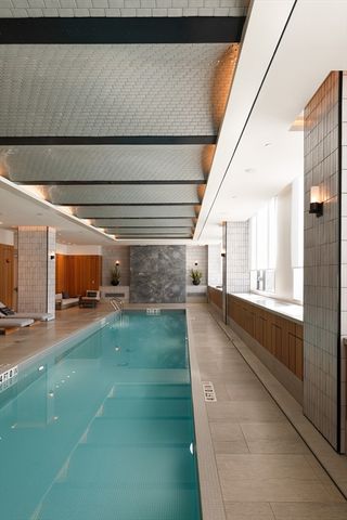 a living room with furniture a window and a chandelier