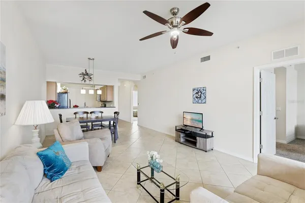a living room with furniture and a chandelier