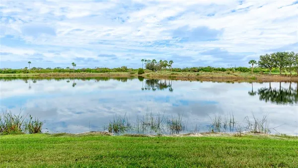 a view of a lake with houses in the back