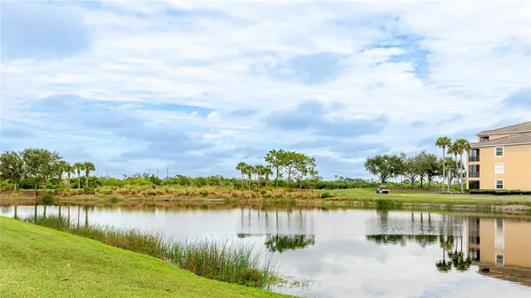 a view of a lake with houses in the back
