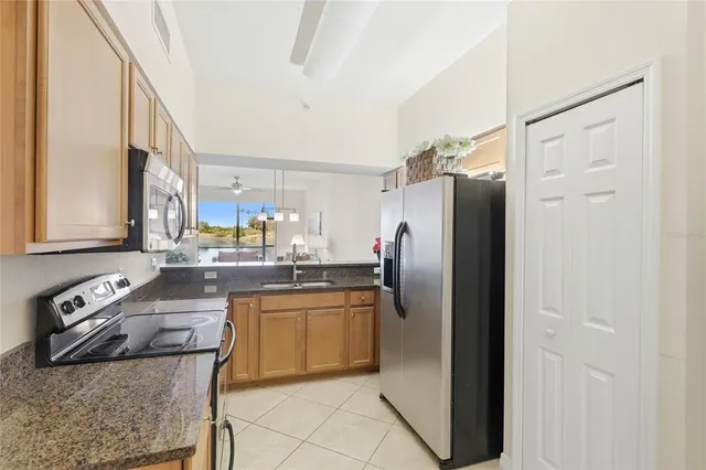a kitchen with stainless steel appliances granite countertop a refrigerator and a stove