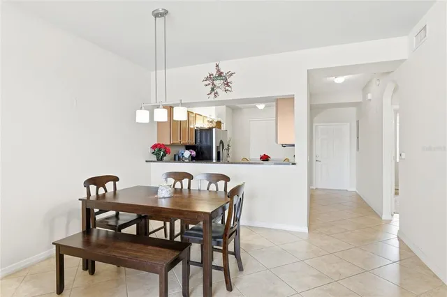 a view of a dining room with furniture and chandelier