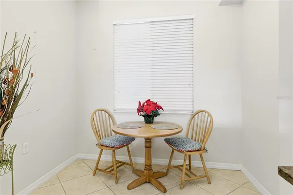 a view of a dining room with furniture and a potted plant