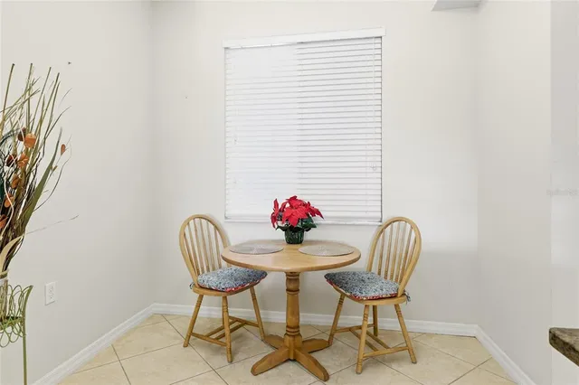 a view of a dining room with furniture and a potted plant