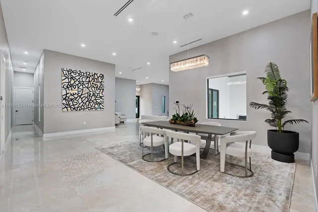 a living room with furniture a potted plant and a table