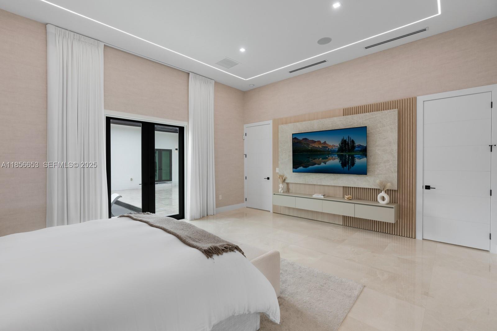 80 Northwest 129th Avenue Miami, FL 33182 - Photo 15 of 34 a bedroom with a bed and a flat screen tv