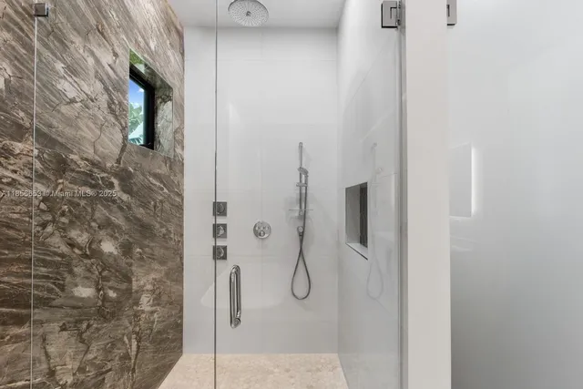 a bathroom with a glass shower door