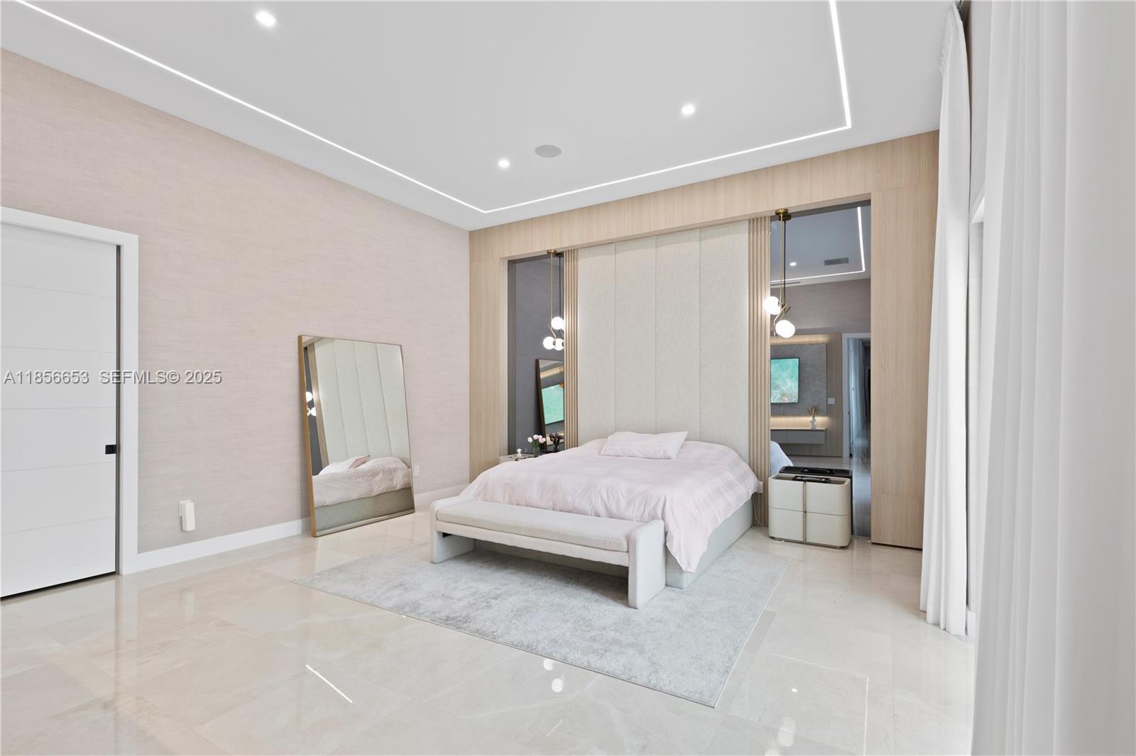 80 Northwest 129th Avenue Miami, FL 33182 - Photo 21 of 34 a spacious bedroom with a bed and a lamp