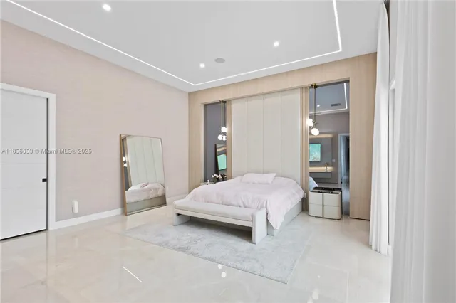 a spacious bedroom with a bed and a lamp