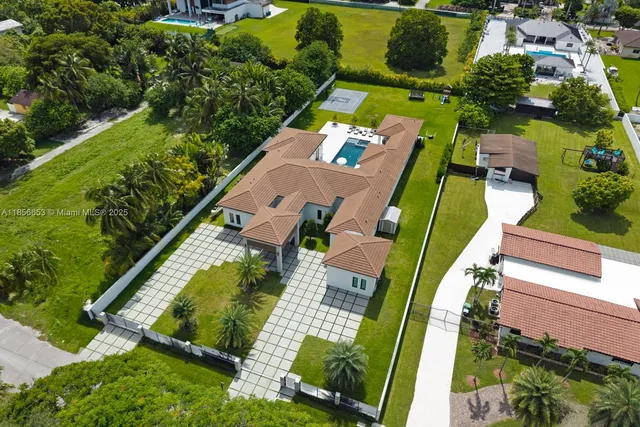 an aerial view of a house with a garden and swimming pool
