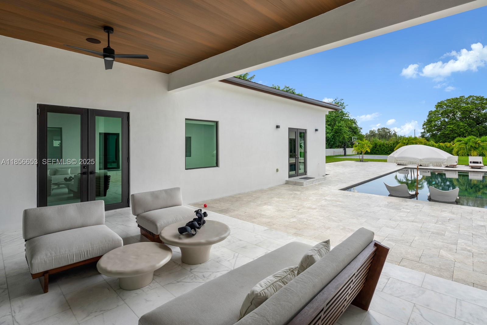 80 Northwest 129th Avenue Miami, FL 33182 - Photo 31 of 34 a living room with furniture and a chandelier