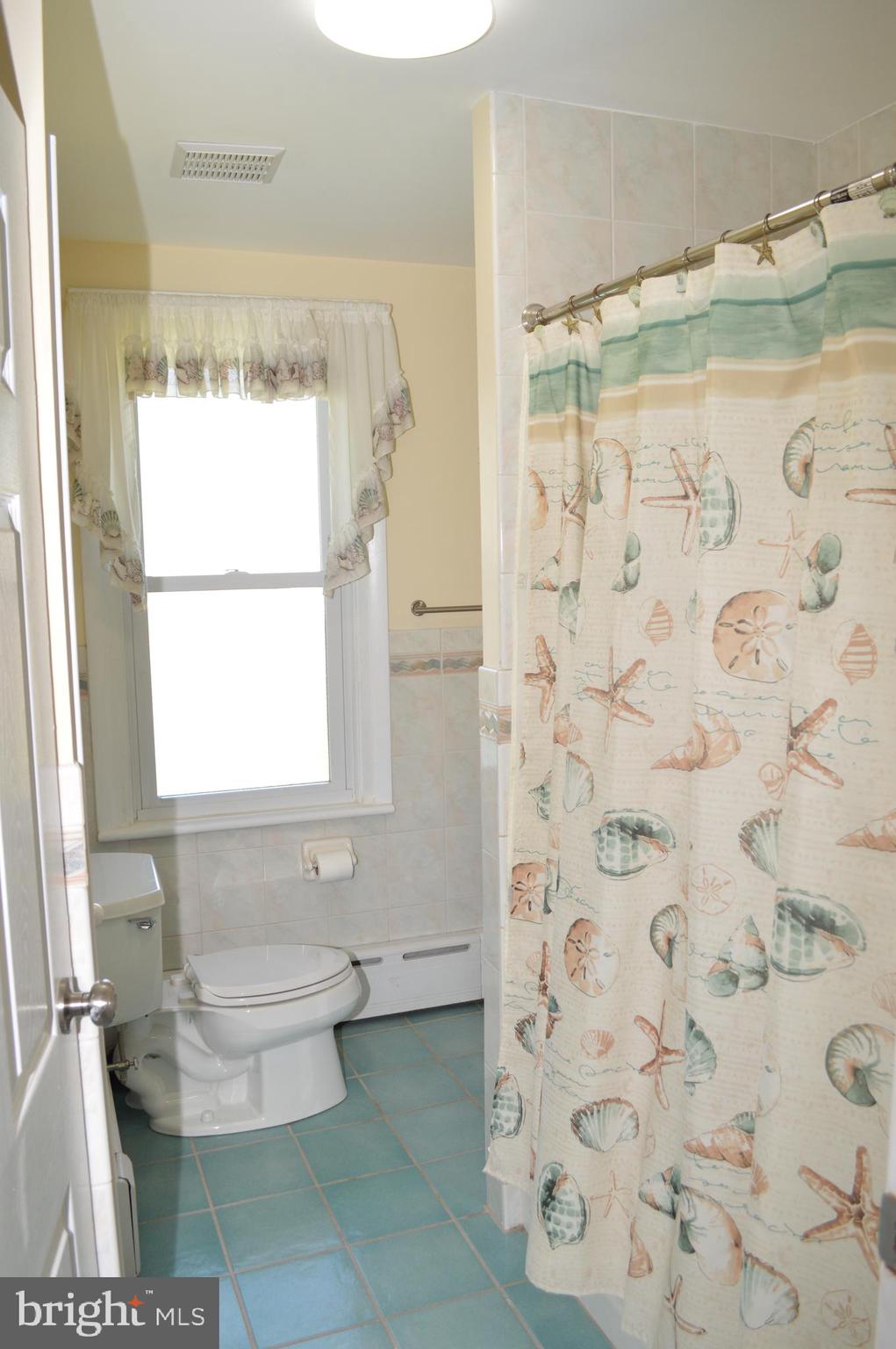 204 Ryers Avenue Cheltenham, PA 19012 - Photo 27 of 51 a bathroom with a toilet and a shower curtain