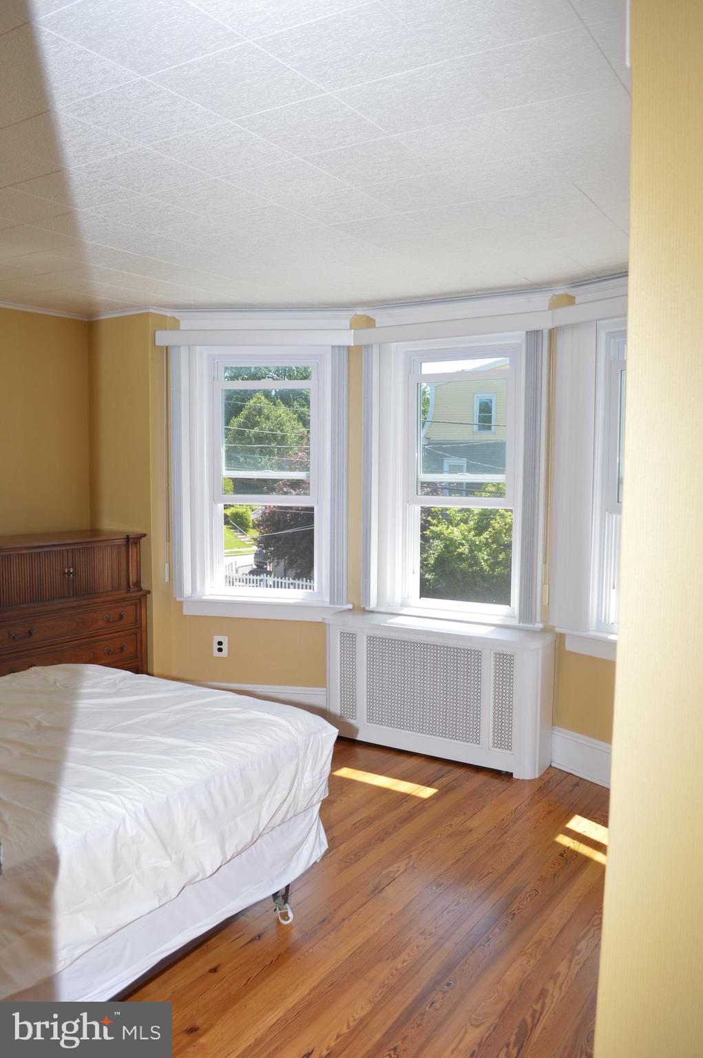 204 Ryers Avenue Cheltenham, PA 19012 - Photo 38 of 51 a spacious bedroom with a bed and wooden floor