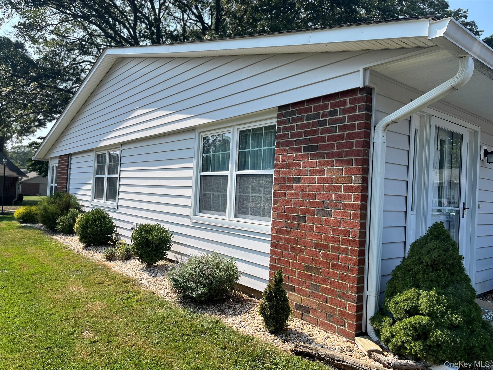 186 Ventry Court, Unit D Ridge, NY 11961 - Photo 1 of 1 a front view of a house with a yard