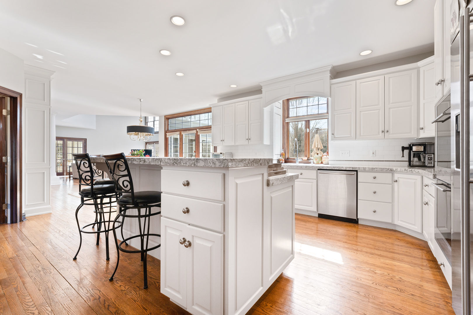 5-n098 Maple Court St. Charles, IL 60175 - Photo 11 of 34 a kitchen with white cabinets stainless steel appliances and dining table