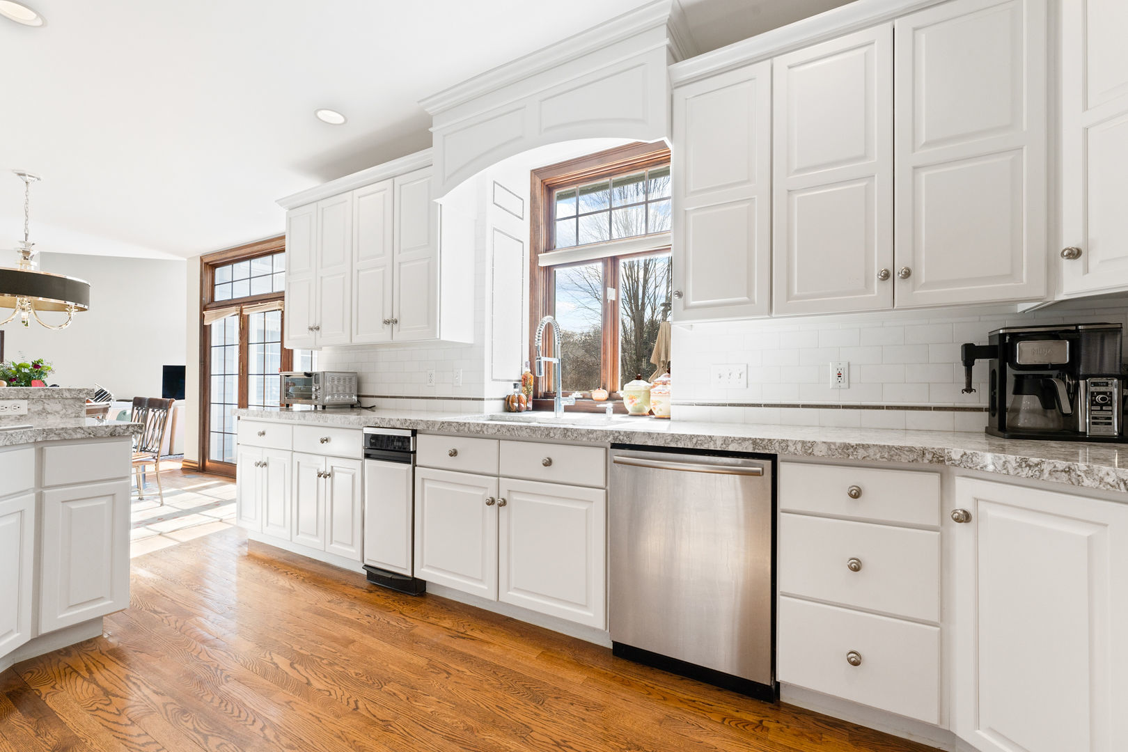 5-n098 Maple Court St. Charles, IL 60175 - Photo 12 of 34 a kitchen with granite countertop white cabinets white appliances with a sink and dishwasher