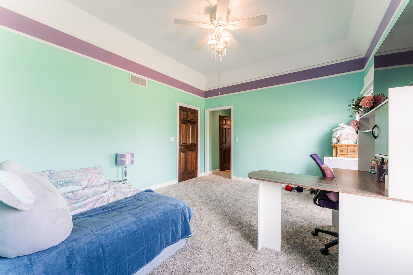 5-n098 Maple Court St. Charles, IL 60175 - Photo 28 of 34 a bedroom with a bed and a chandelier