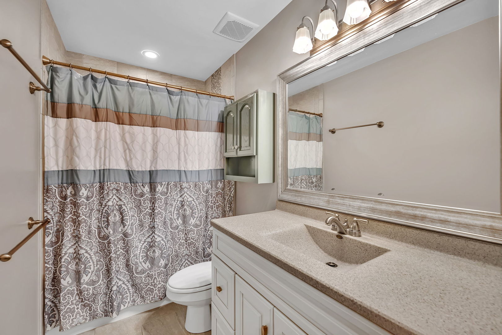 700 Evergreen Court Romeoville, IL 60446 - Photo 13 of 27 a bathroom with a sink a toilet and shower curtain