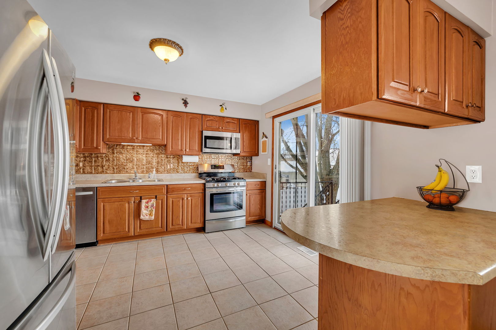 700 Evergreen Court Romeoville, IL 60446 - Photo 8 of 27 a kitchen with stainless steel appliances granite countertop a refrigerator sink and cabinets