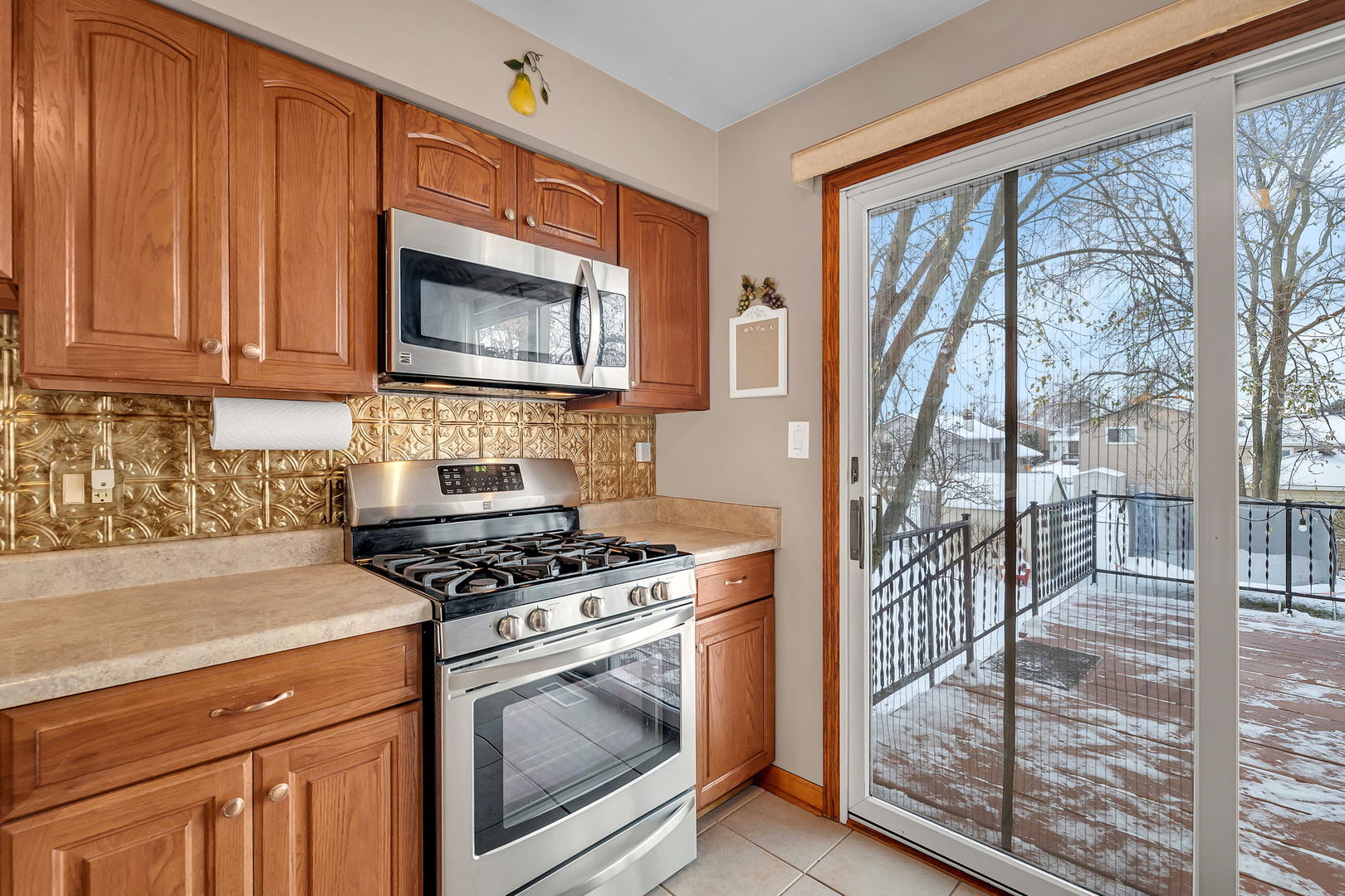 700 Evergreen Court Romeoville, IL 60446 - Photo 10 of 27 a kitchen with granite countertop a stove top oven cabinetry a sink and a view of living room