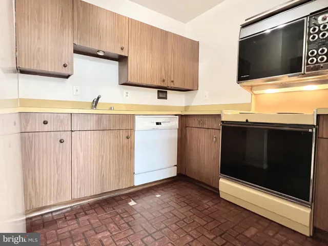 a kitchen with stainless steel appliances a stove a sink and a microwave
