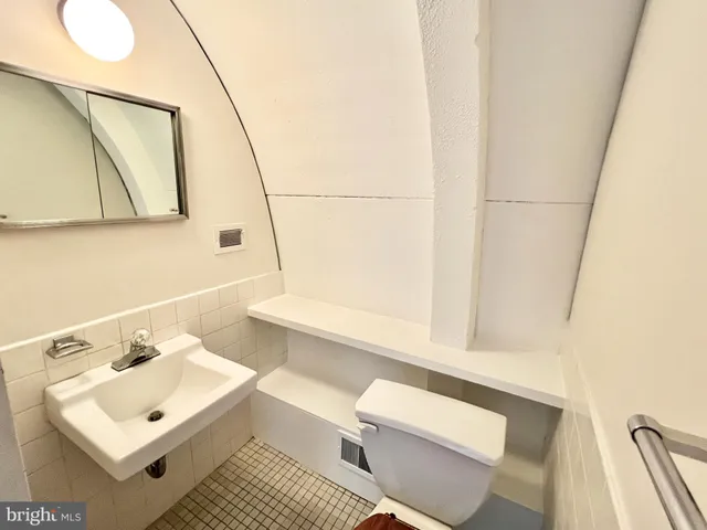 a bathroom with a sink toilet and mirror