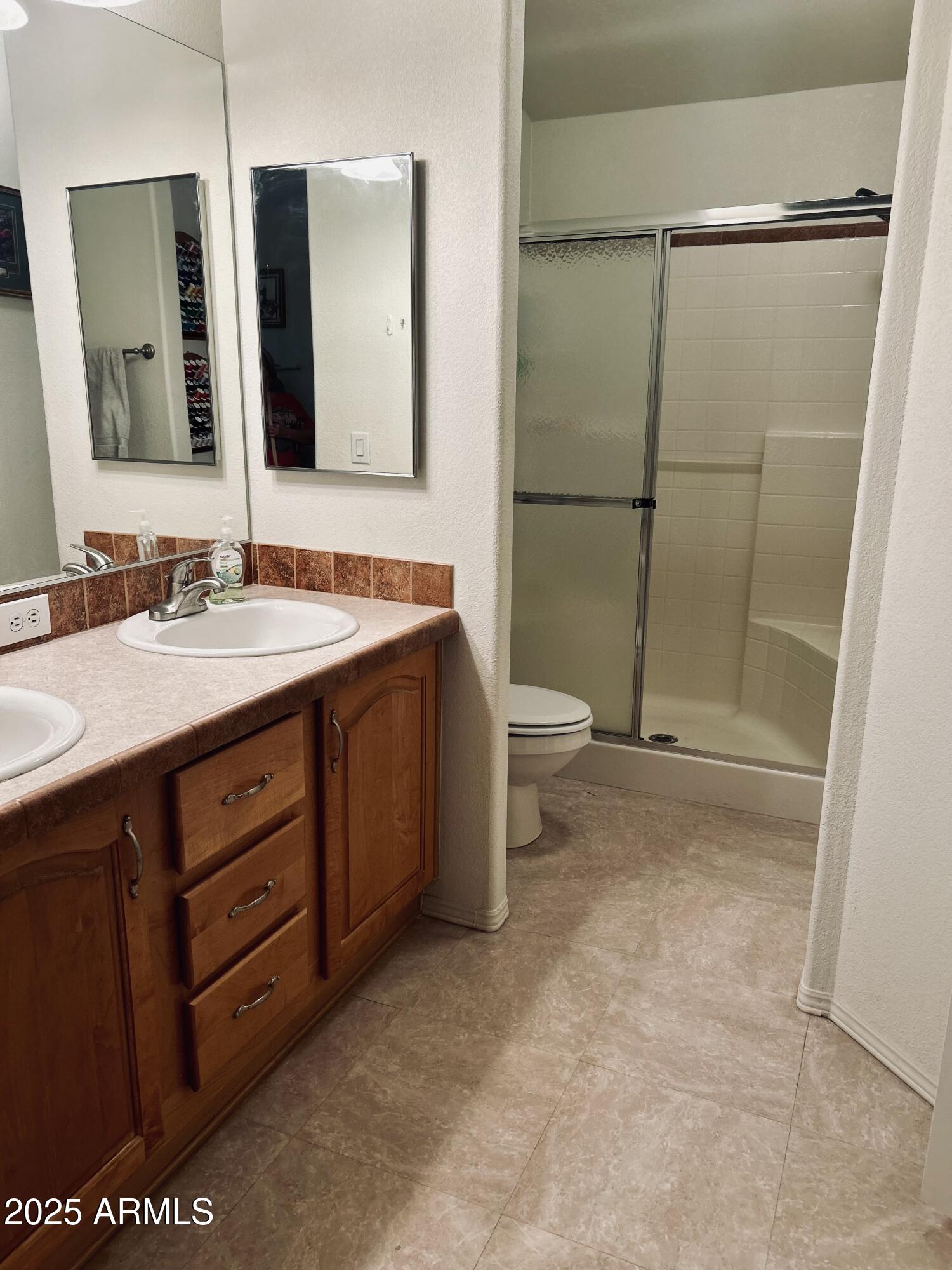 3301 South Goldfield Road, Unit 3011 Apache Junction, AZ 85119 - Photo 16 of 65 a bathroom with a sink and a mirror