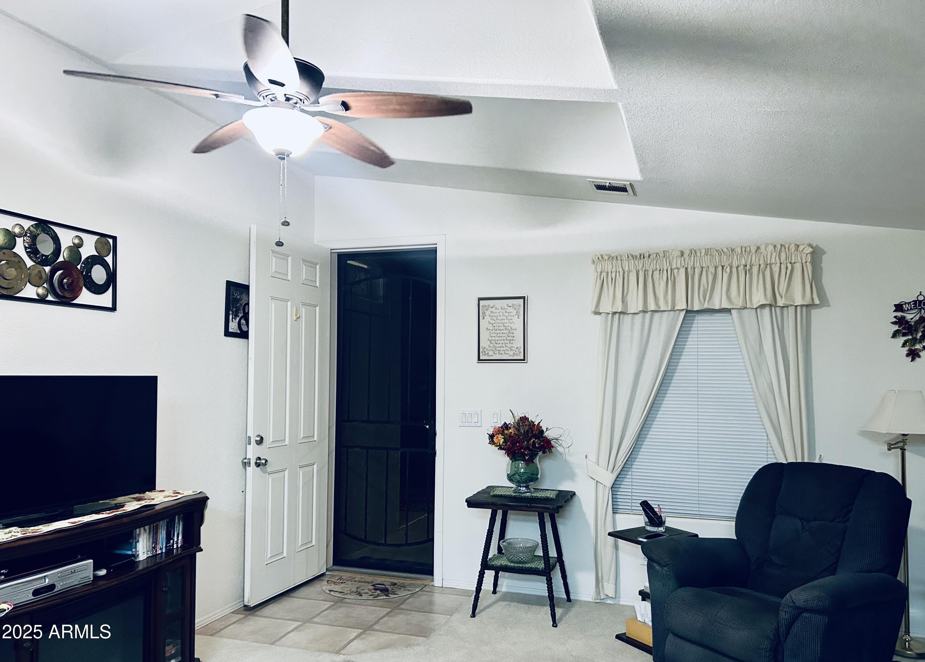 3301 South Goldfield Road, Unit 3011 Apache Junction, AZ 85119 - Photo 30 of 65 a living room with furniture and a flat screen tv