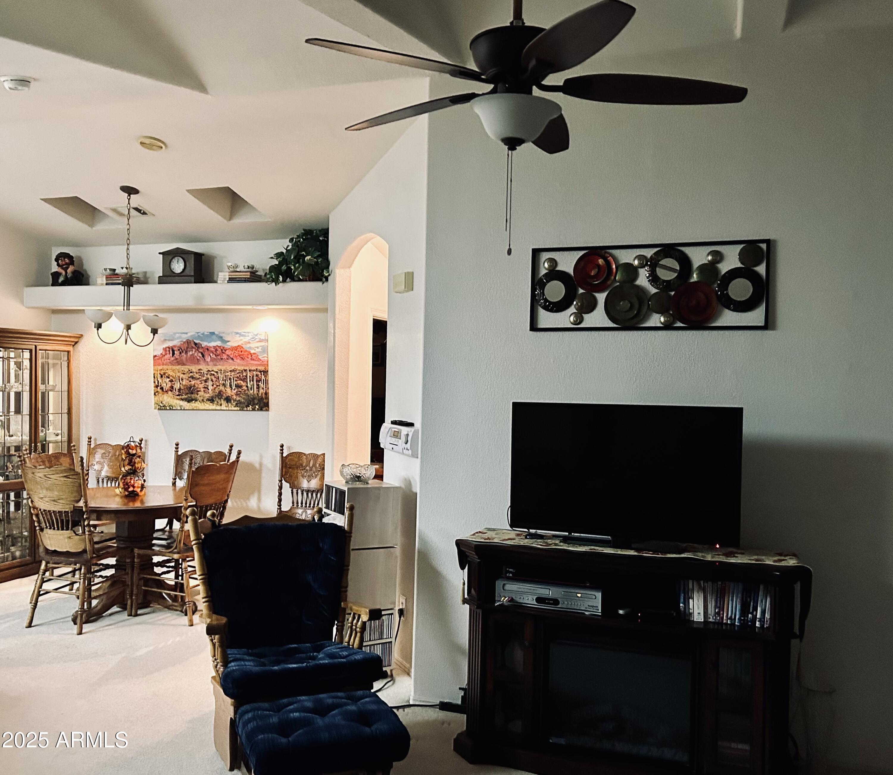 3301 South Goldfield Road, Unit 3011 Apache Junction, AZ 85119 - Photo 33 of 65 a living room with furniture a flat screen tv and a fireplace