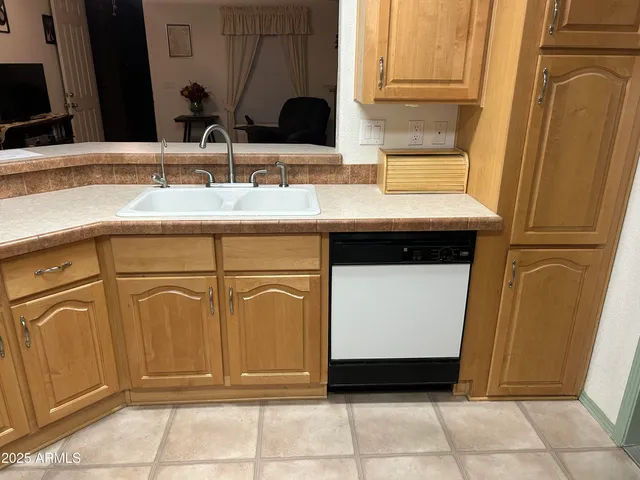 a view of a swimming pool with a lawn chairs under palm trees
