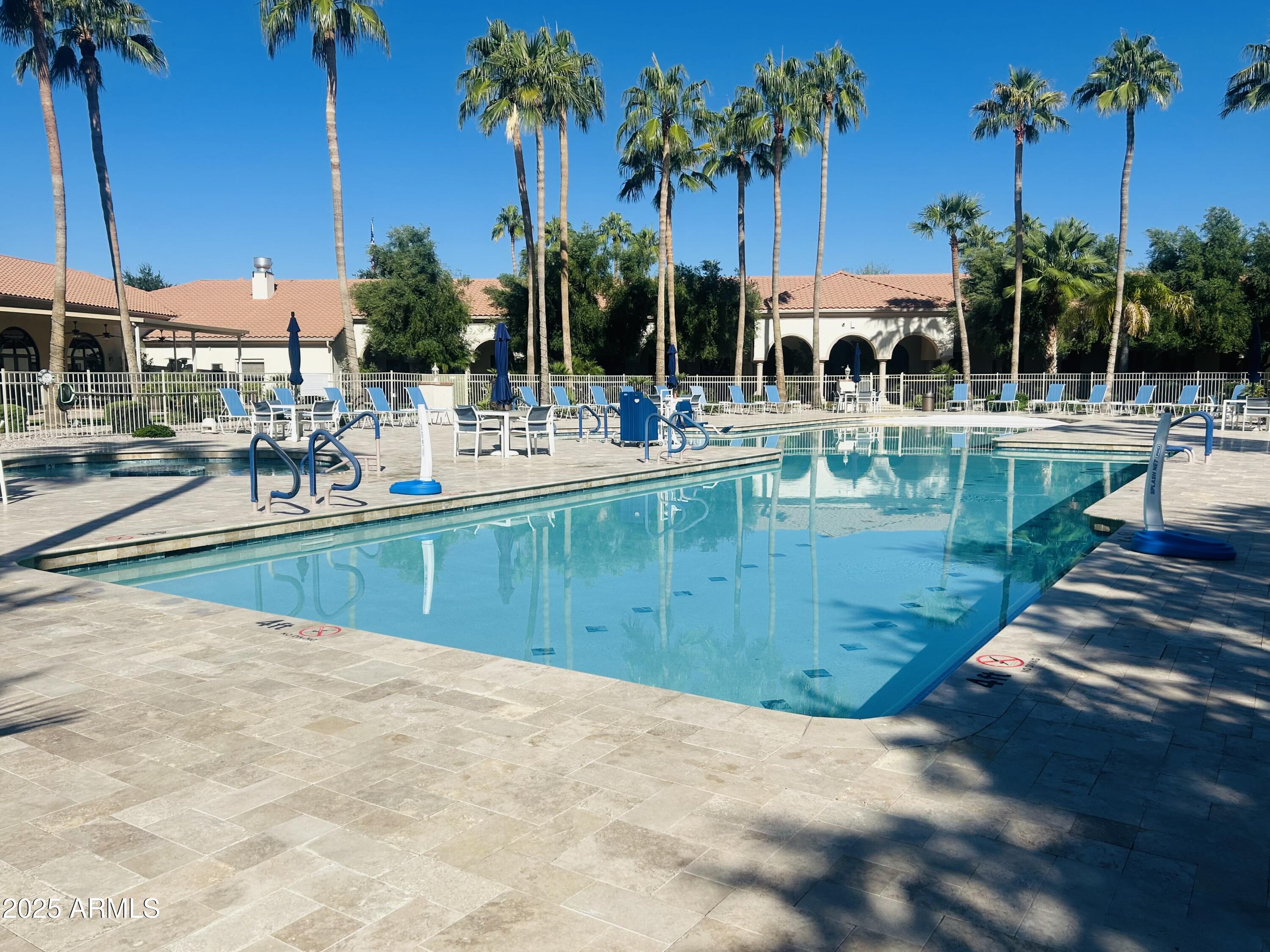 3301 South Goldfield Road, Unit 3011 Apache Junction, AZ 85119 - Photo 56 of 65 a view of a swimming pool with chairs