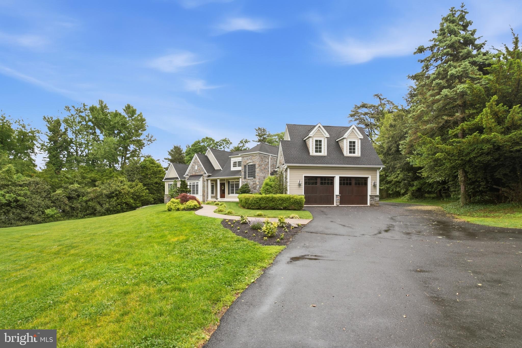 1031 Coates Road Jenkintown, PA 19046 - Photo 5 of 66 a view of a big house with a big yard and large trees