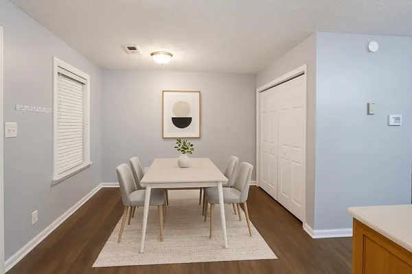 a view of a dining room with furniture and wooden floor
