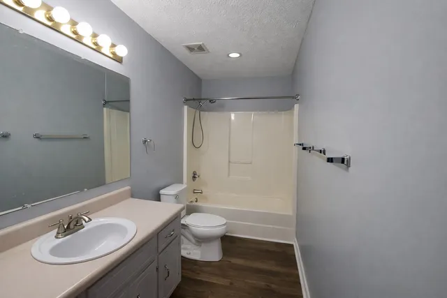 a bathroom with a sink double vanity granite toilet and shower