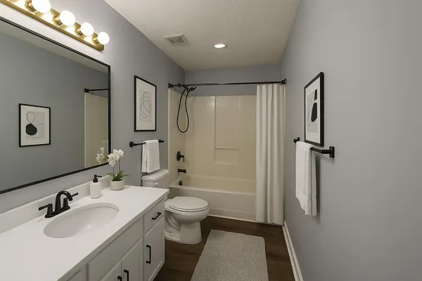 a bathroom with a sink toilet and shower