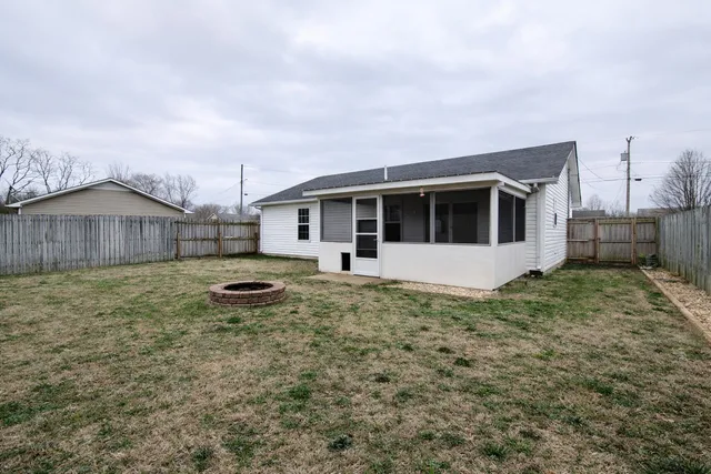 a view of a house with a backyard