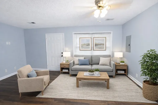 a living room with furniture and a chandelier