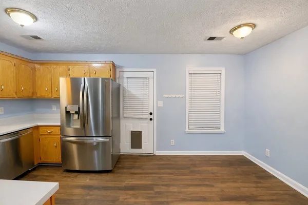 a kitchen with stainless steel appliances granite countertop a refrigerator a sink and a stove