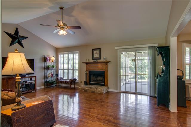 835 Cothran Road Columbia, TN 38401 - Photo 4 of 20 The Living Room features a wood burning fireplace, vaulted ceiling & hardwood floors. Hardwood Floors through out the home!