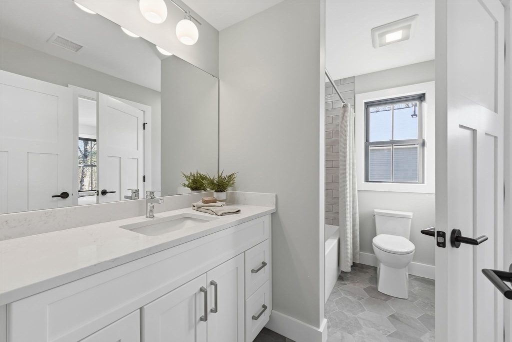 37 Landy Avenue Northampton, MA 01062 - Photo 29 of 40 a bathroom with a sink a toilet and a mirror
