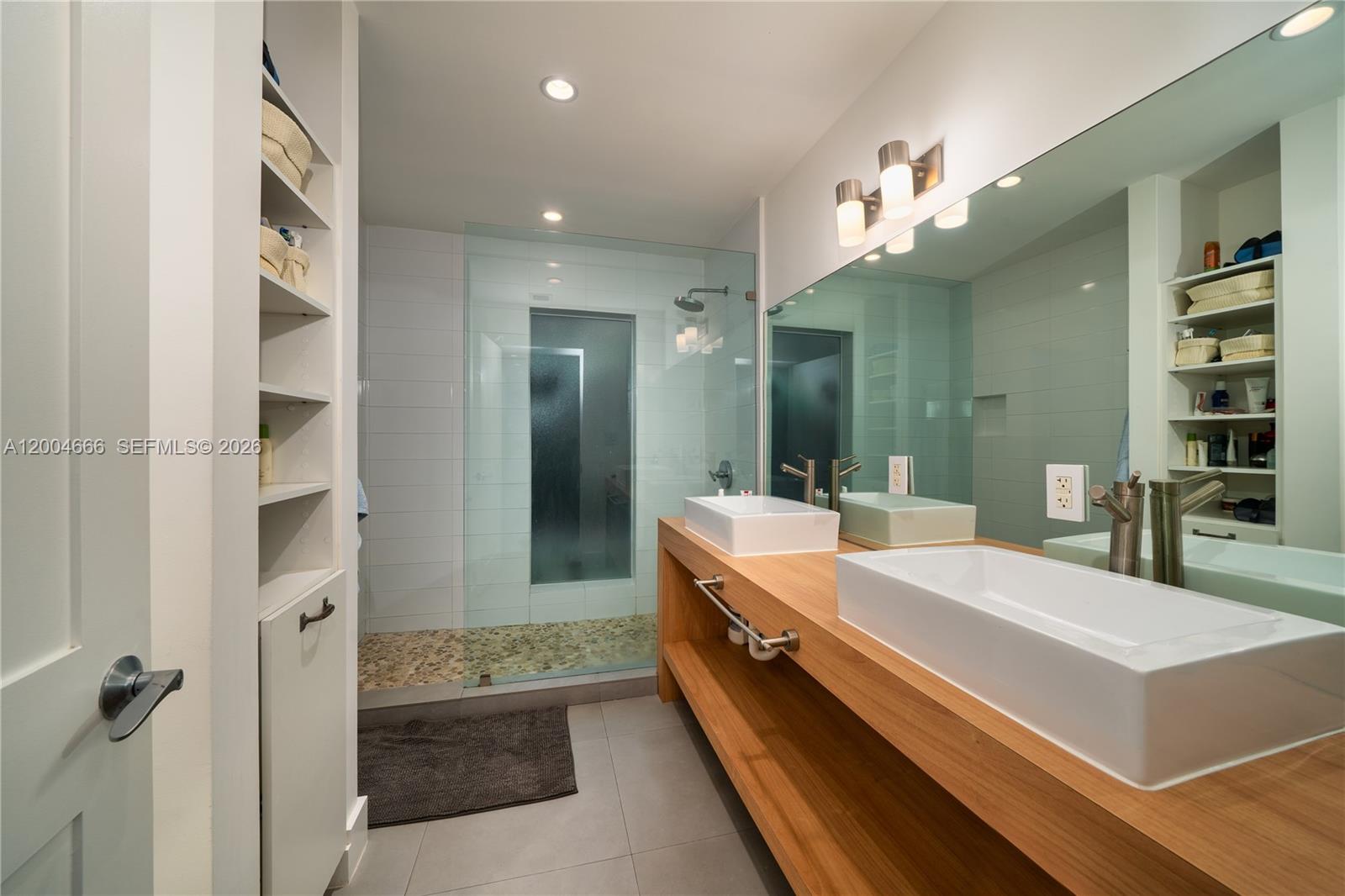 861 Harbor Drive Key Biscayne, FL 33149 - Photo 20 of 33 a large bathroom with a double vanity sink a mirror and shower