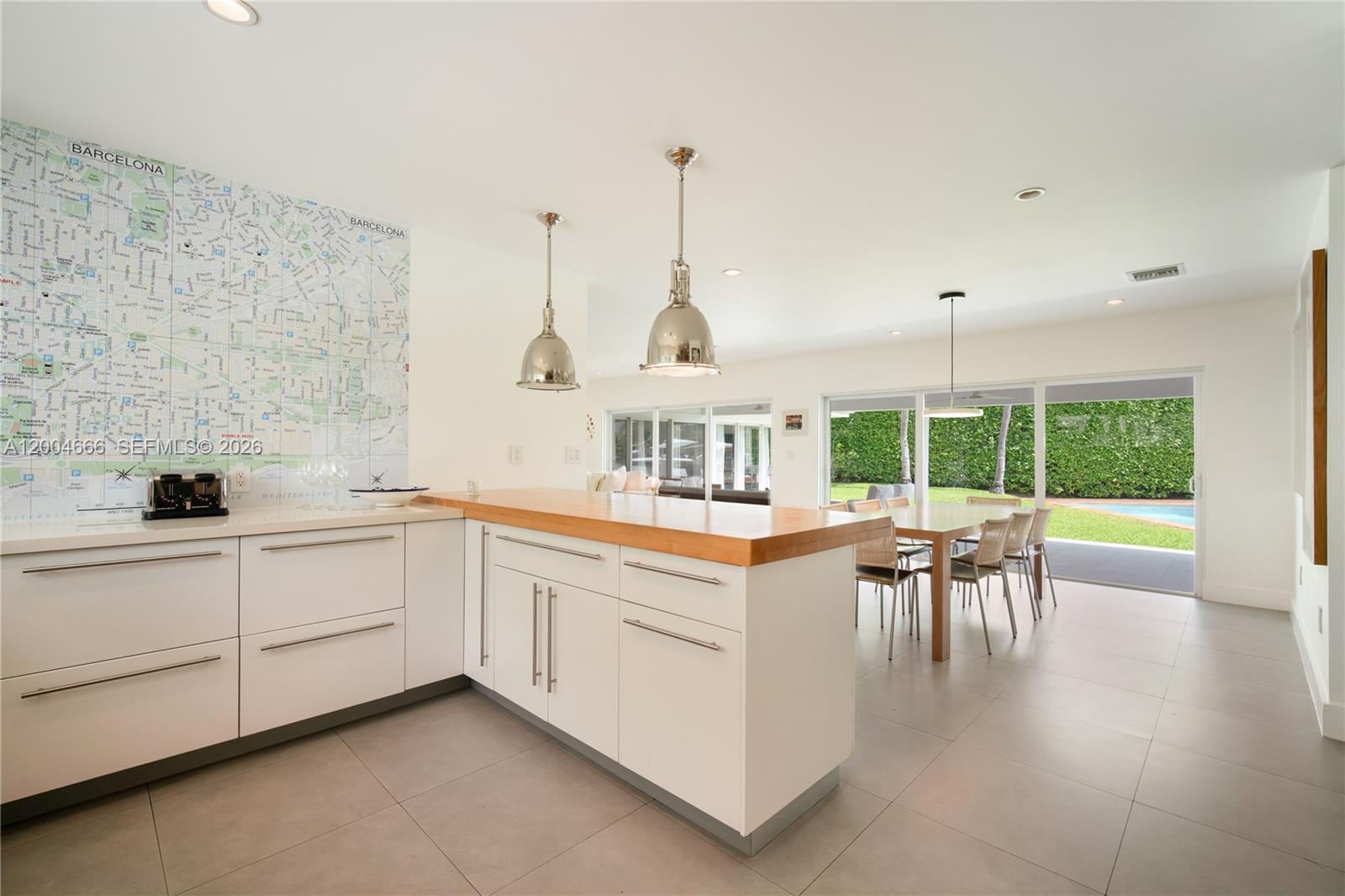 861 Harbor Drive Key Biscayne, FL 33149 - Photo 7 of 33 a kitchen with a table chairs and a view of living room