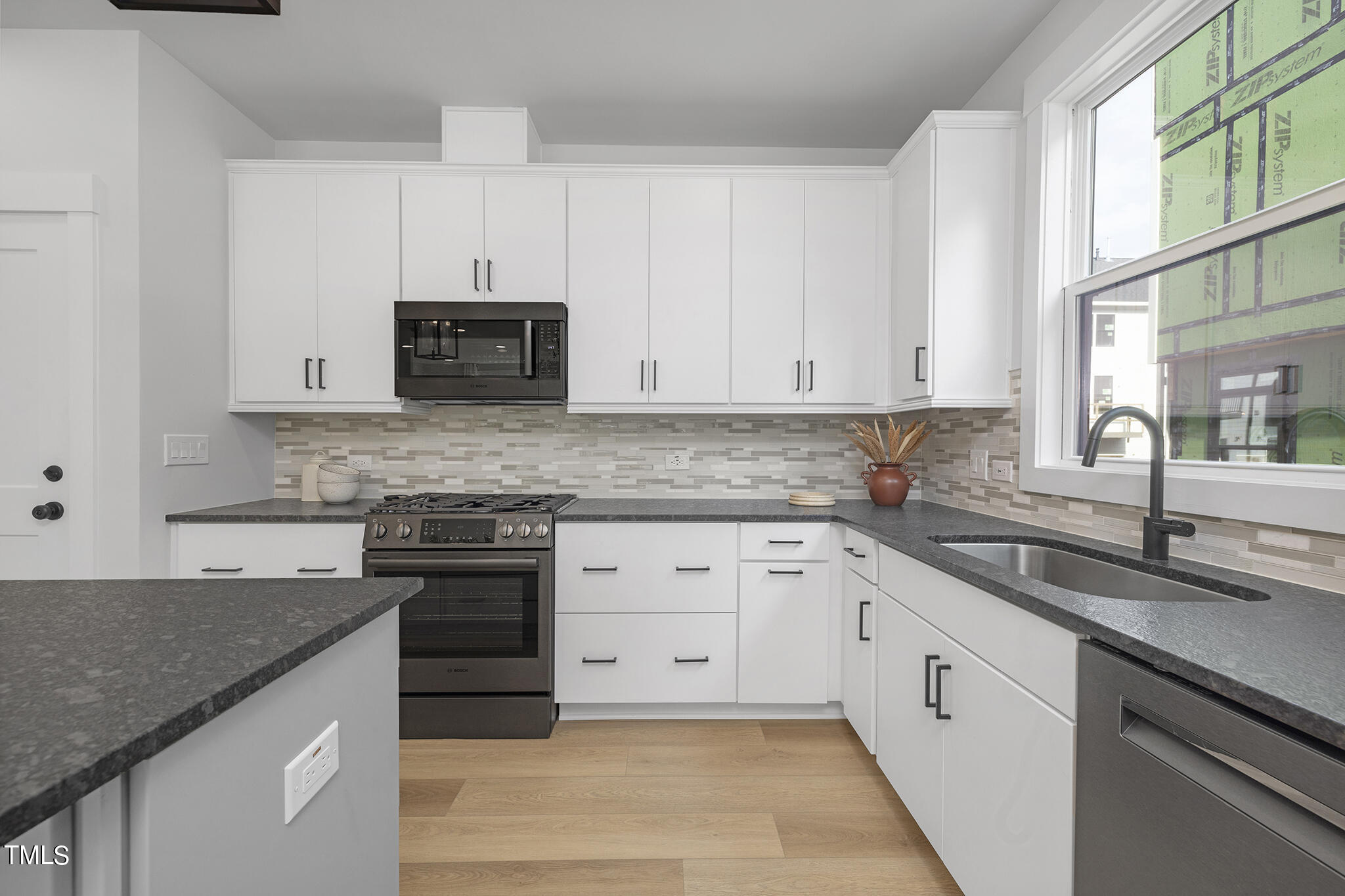 811 Fireship Road Fuquay-Varina, NC 27526 - Photo 12 of 35 a kitchen with granite countertop white cabinets and a granite counter tops