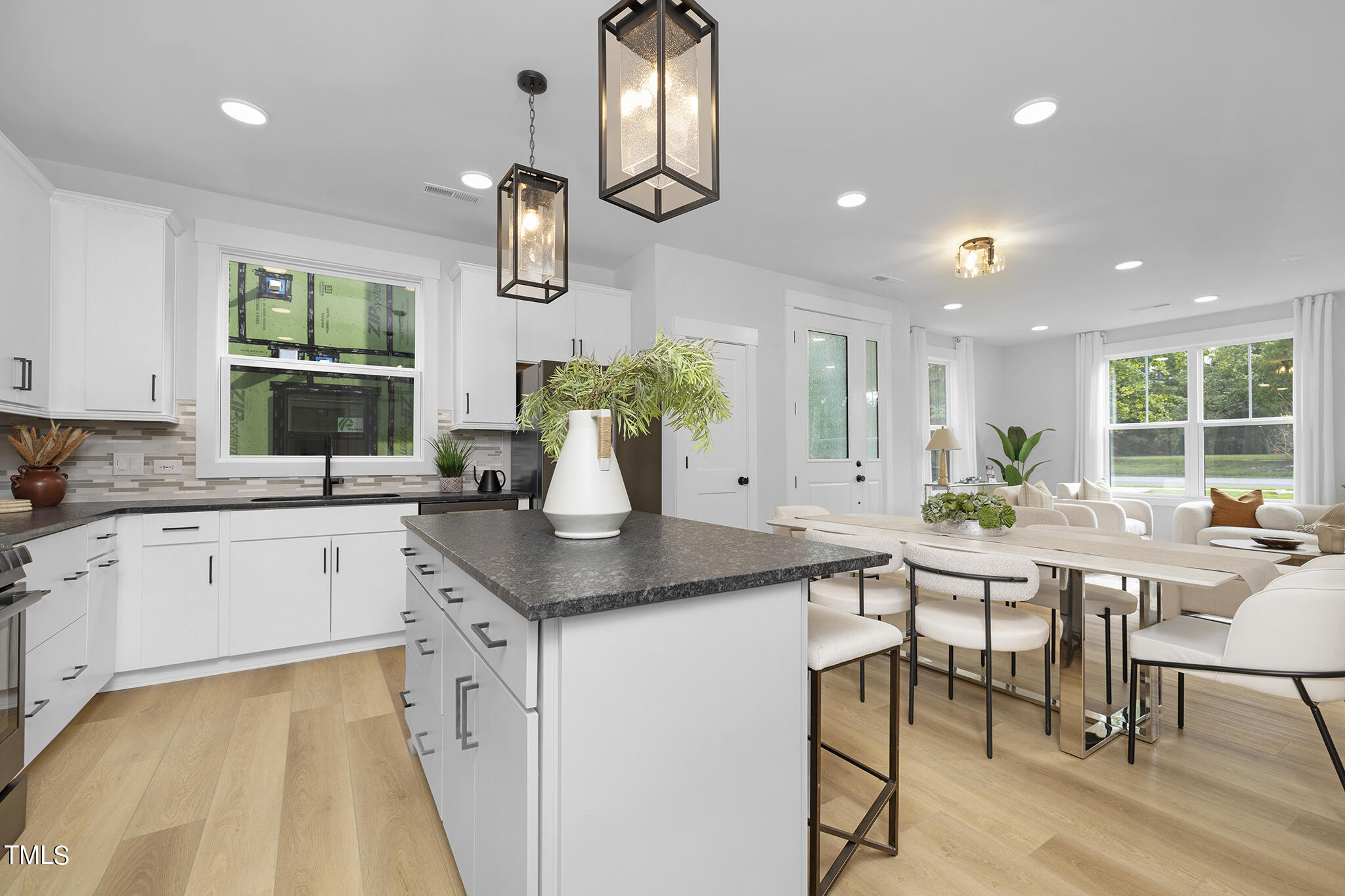 811 Fireship Road Fuquay-Varina, NC 27526 - Photo 14 of 35 a kitchen with a table chairs stove and cabinets