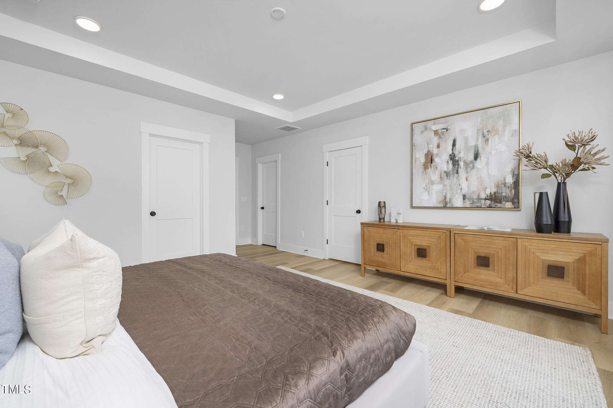 811 Fireship Road Fuquay-Varina, NC 27526 - Photo 20 of 35 a spacious bedroom with a bed and a painting on the wall