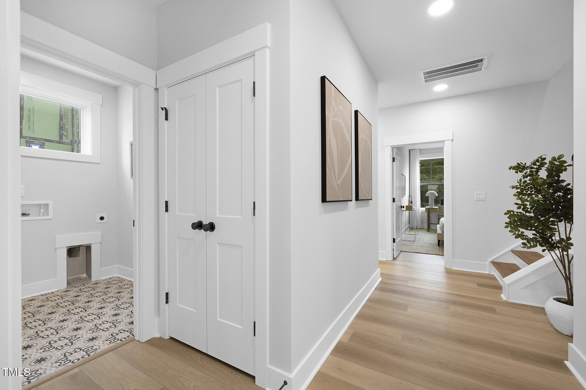 811 Fireship Road Fuquay-Varina, NC 27526 - Photo 27 of 35 a view of a hallway with wooden floor and a livingroom