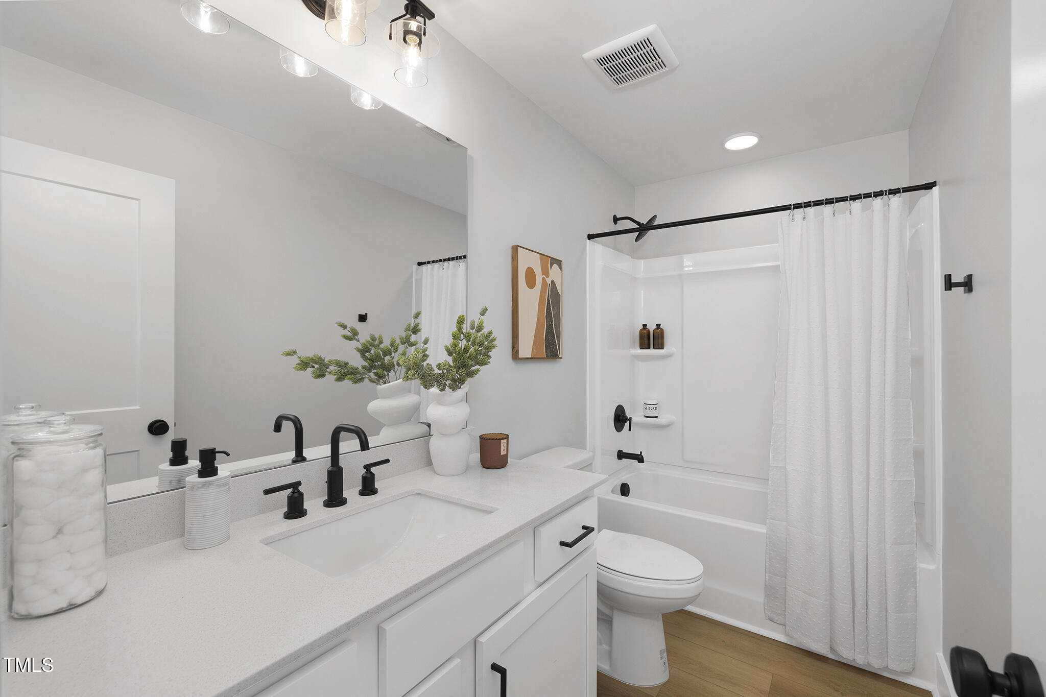811 Fireship Road Fuquay-Varina, NC 27526 - Photo 34 of 35 a bathroom with a sink a toilet and shower curtain