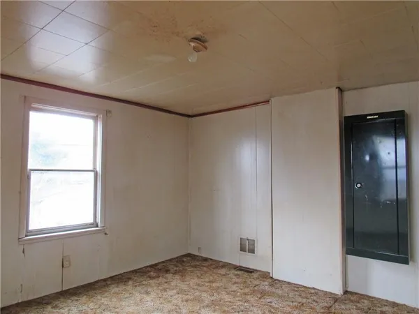 an empty room with windows and closet